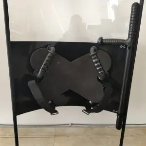 Anti riot shield with baton holder